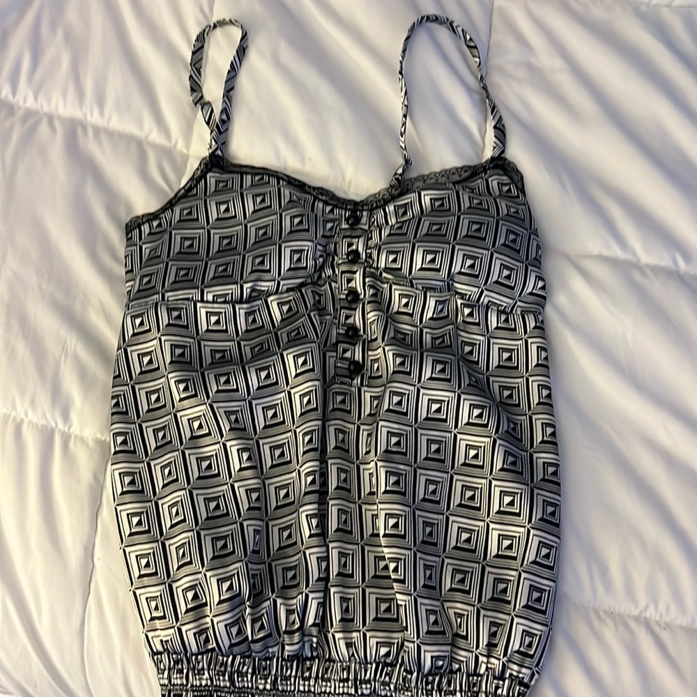 Black and white Small cami style shirt. Elasticized at bottom.